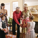 Couple receiving gifts from girl and pageboy (6-7)