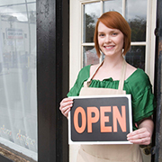Woman holding open sign