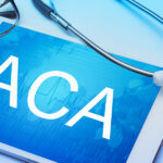 ACA word on tablet screen with medical equipment on background