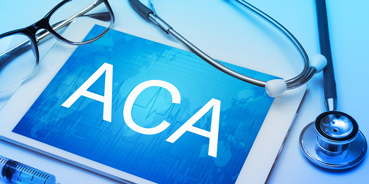 ACA word on tablet screen with medical equipment on background